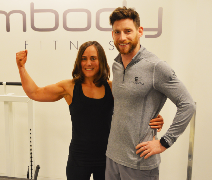 an embody happy client with a male trainer