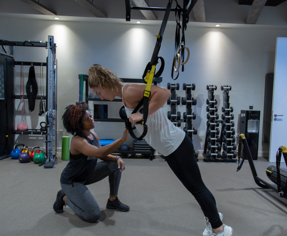 trainer and trainee doing suspensions