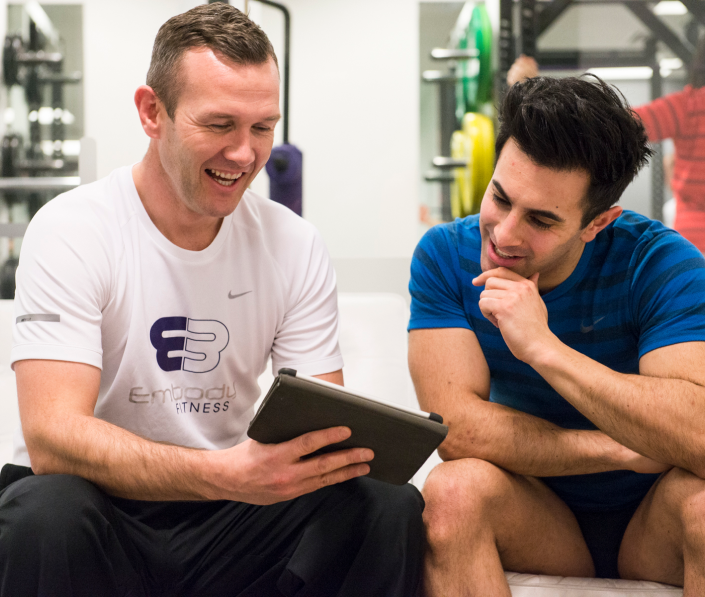 trainer showing ipad screen to trainee