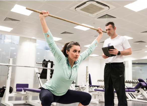 trainee squating with trainer