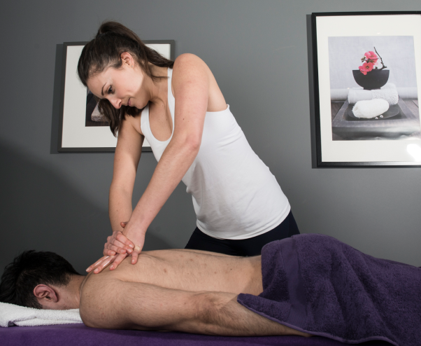 a female therapist is massaging a client