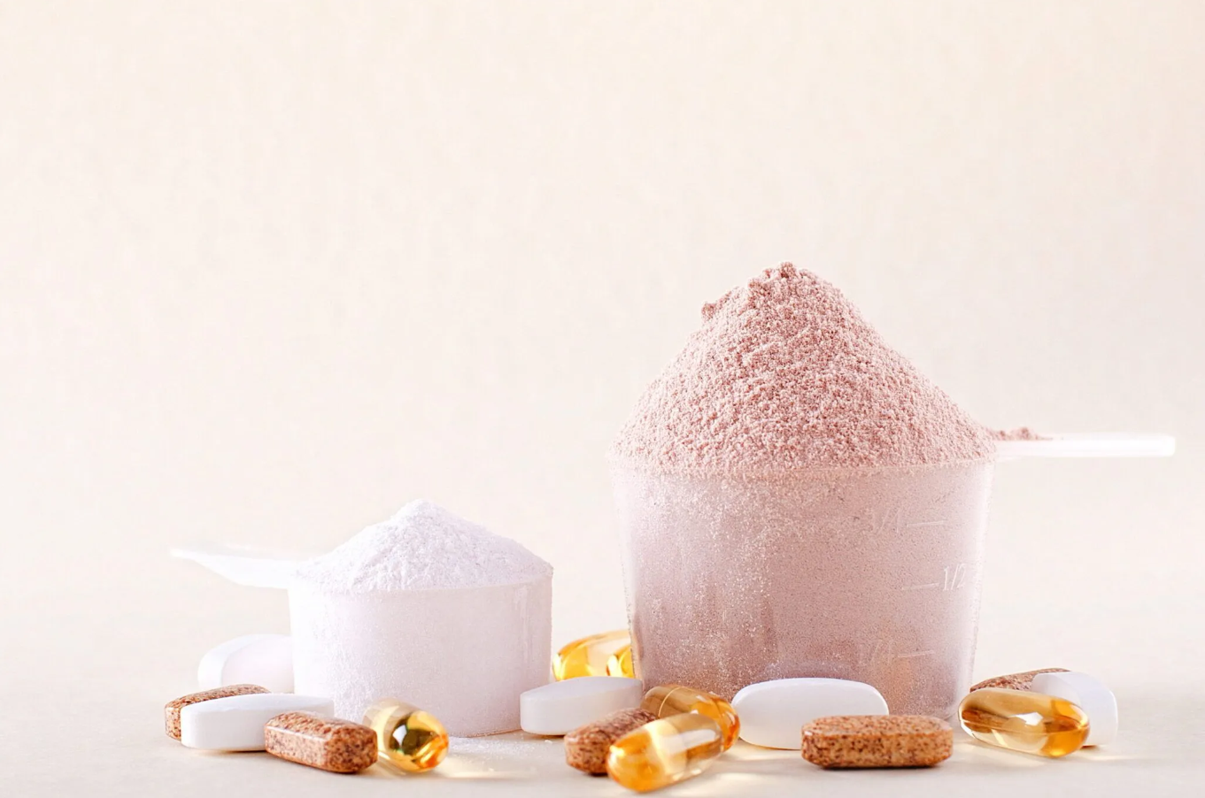 2 scoops of supplements with some multiple vitamin tablets
