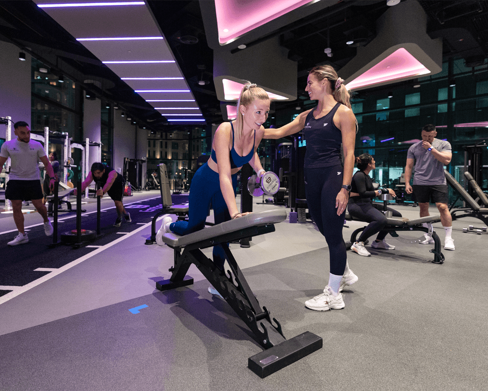 a woman is working out with a female trainer