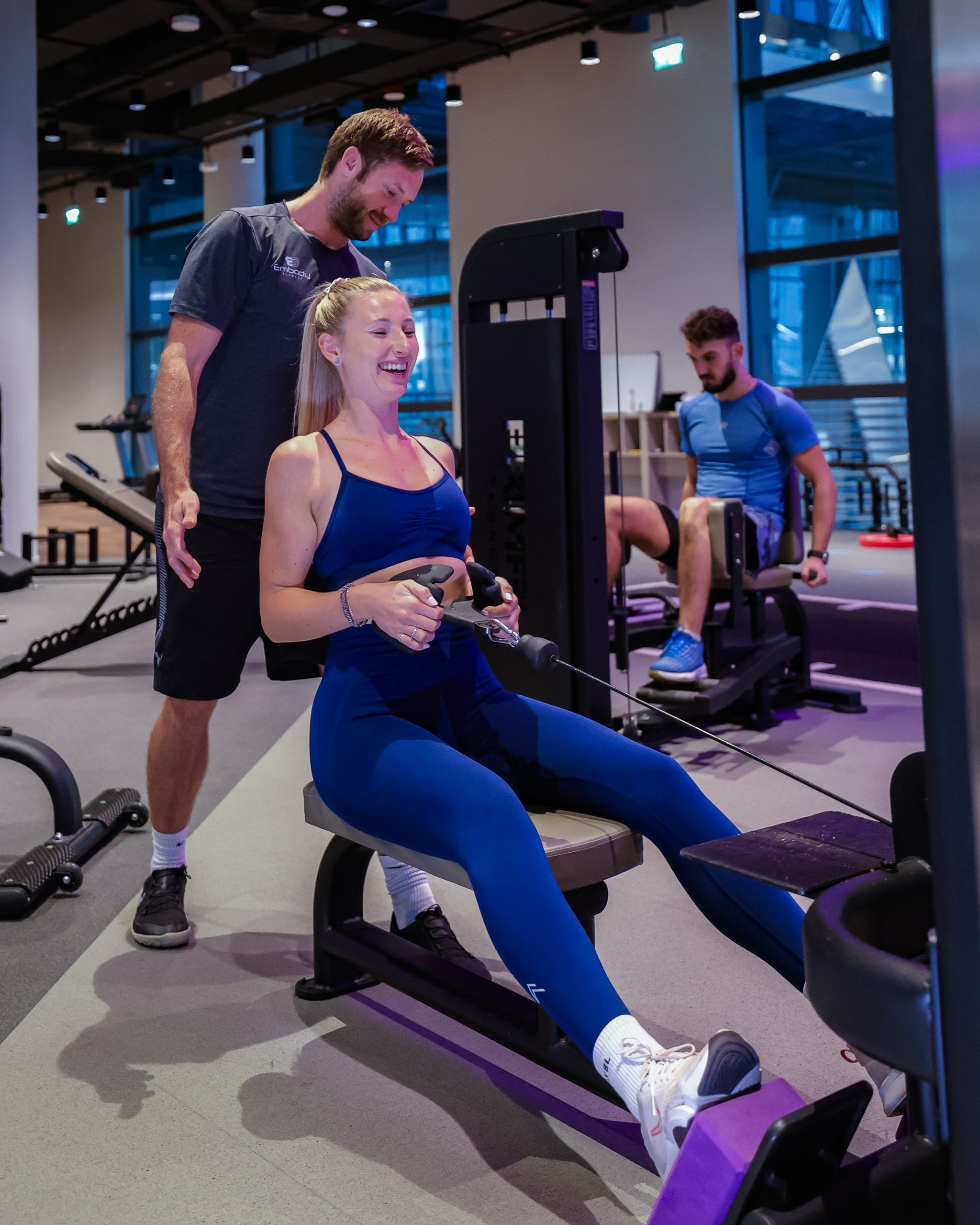 A trainer is training a woman at embody fitness gym