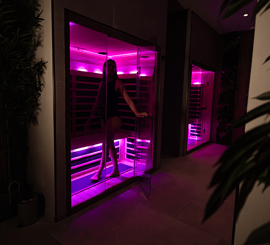 woman walking into infrared sauna